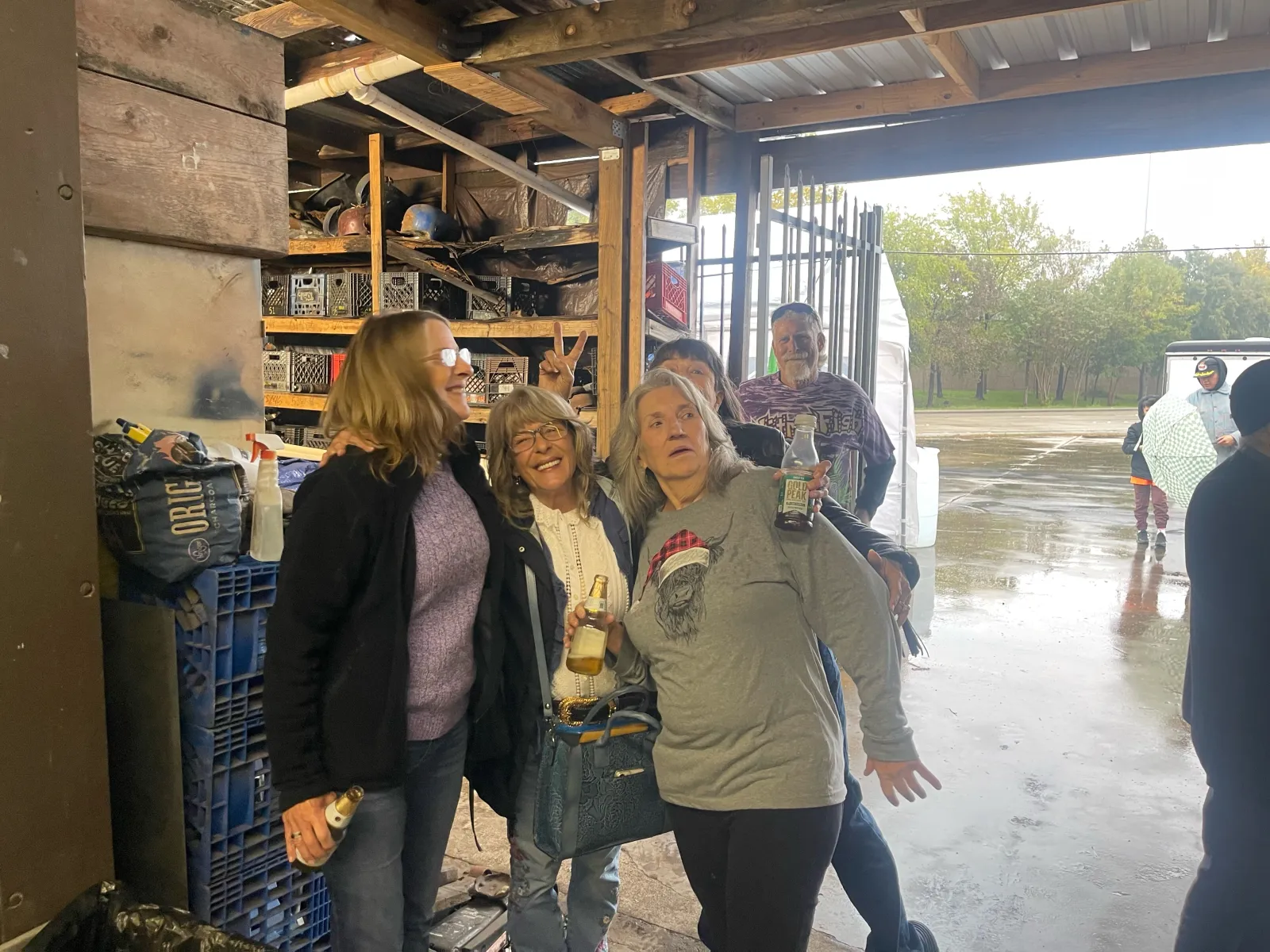 Three women and friends gathered at the open McCreations garage door